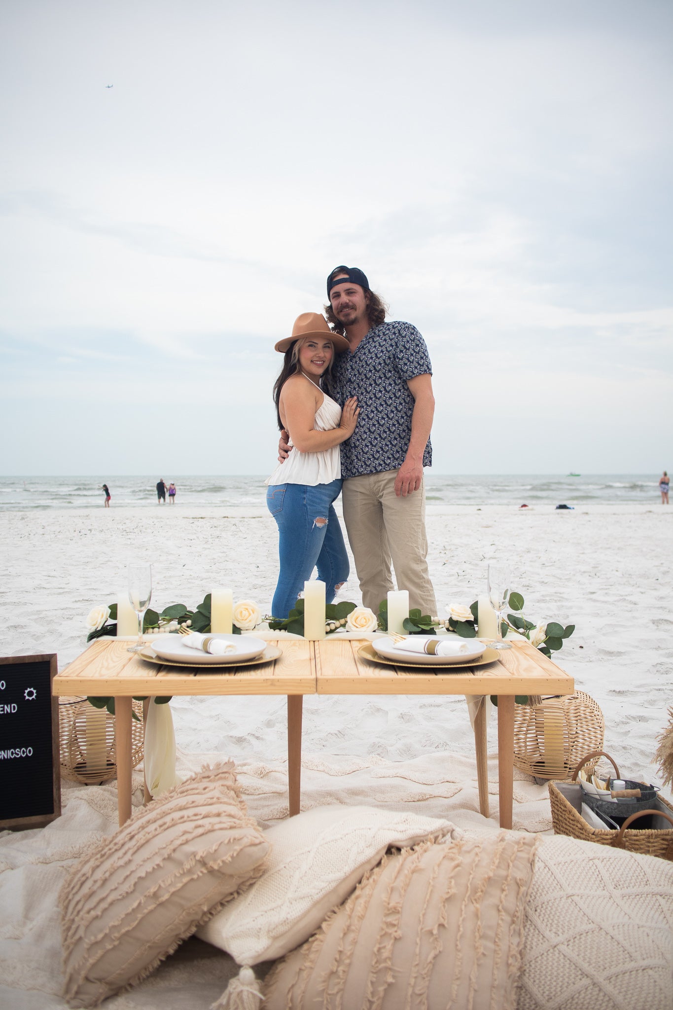 couple enjoying picnic goals package at evening on Fort Myers Beach, Florida